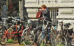 A young professional parks his bike in Amsterdam.