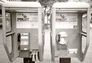 Two telephones in Aachen, Germany - one accepts coins and the other accepts plastic cards.