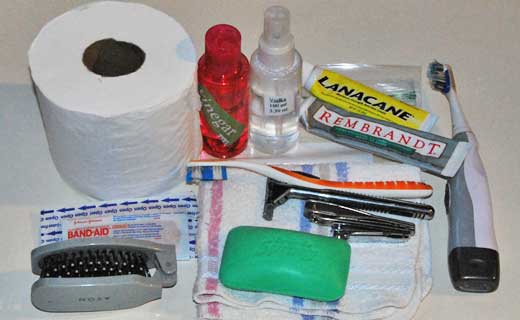 Toothbrush, toilet paper, razor, and other toiletries for travel.