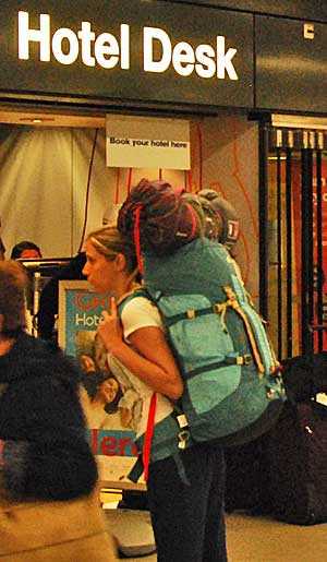 An overloaded backpacker at Amsterdam Schiphol Airport.