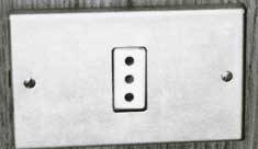 The Italian grounded outlet features three smaller diameter holes in line.