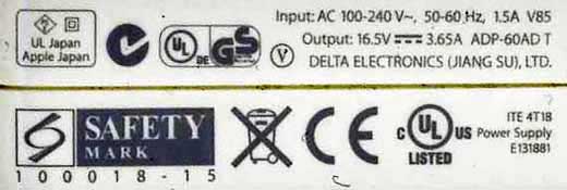 The electrical nameplate of an Apple lap top computer charger.