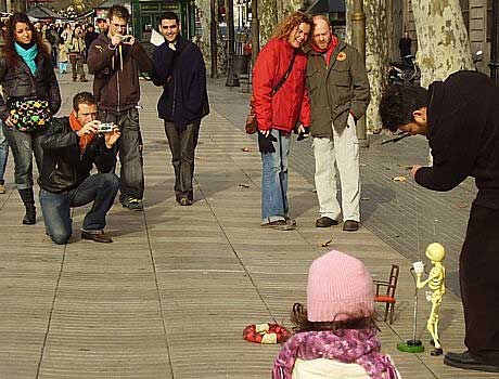 A puppet master and his dancing skeleton entertain us in Barcelona, Spain.