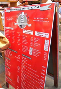 A sidewalk sign board shows the daily offerings at a small restaurant in La Baule, France.
