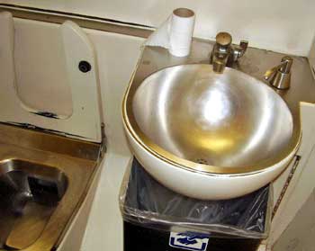 Typical wash basin and pottie in a European train toilet room.