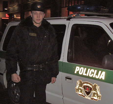 A policeman standing next to his car in Riga, Latvia. http://www.enjoy-europe.com/hte/chap18/Chap18images/P1170105bPolicemanRiga.jpg