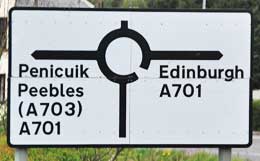 A sign in Scotland indicating that you are about to enter a round about.