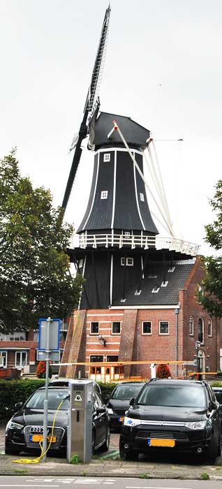 De Adriaan windmill 
and an electric automobile charging station in Haarlem, Nederland, September 2015.